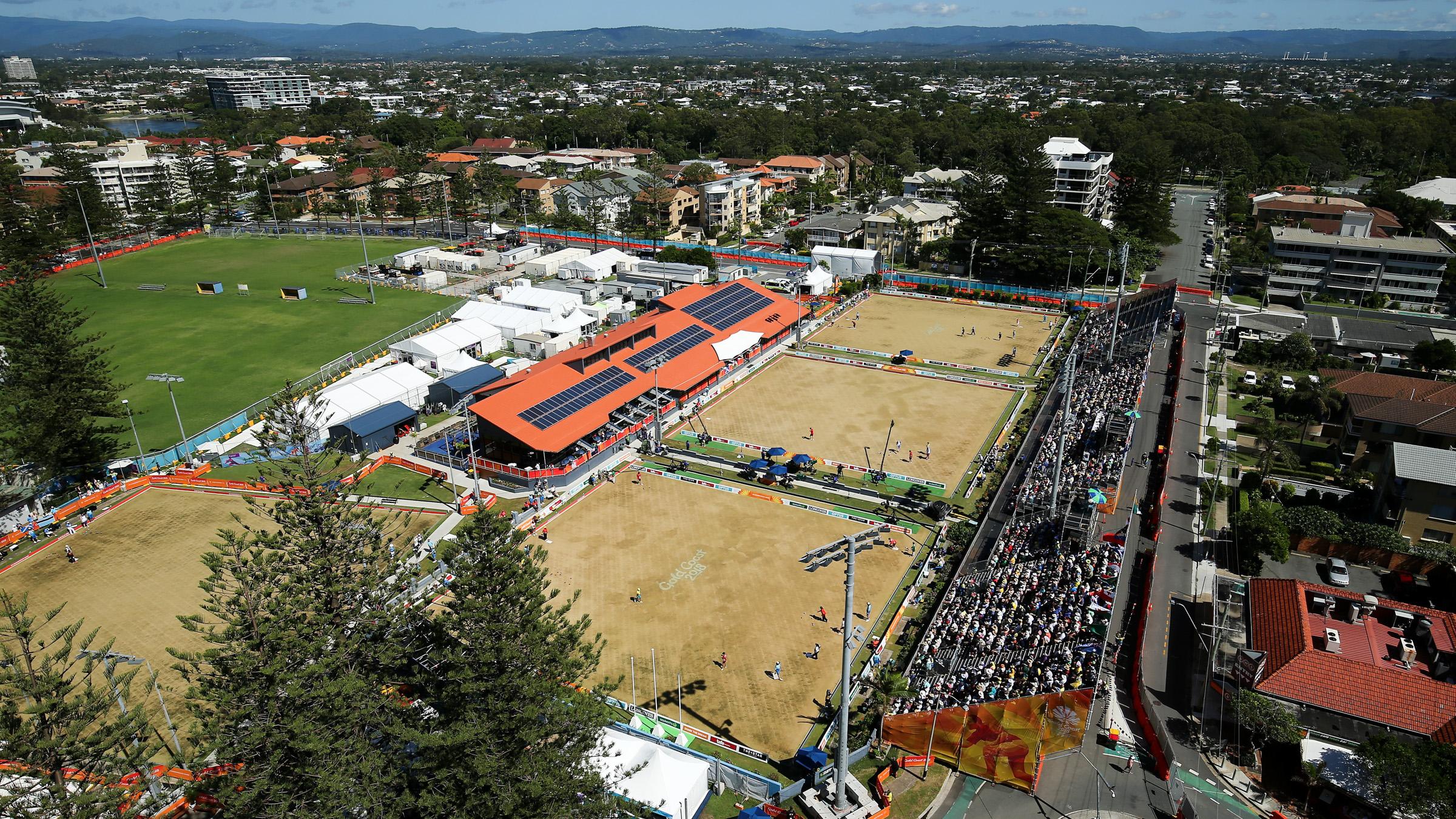 Aerial view of Broadbeach Bowls Club, with a stadium full of people watching a Commonwealth Games event