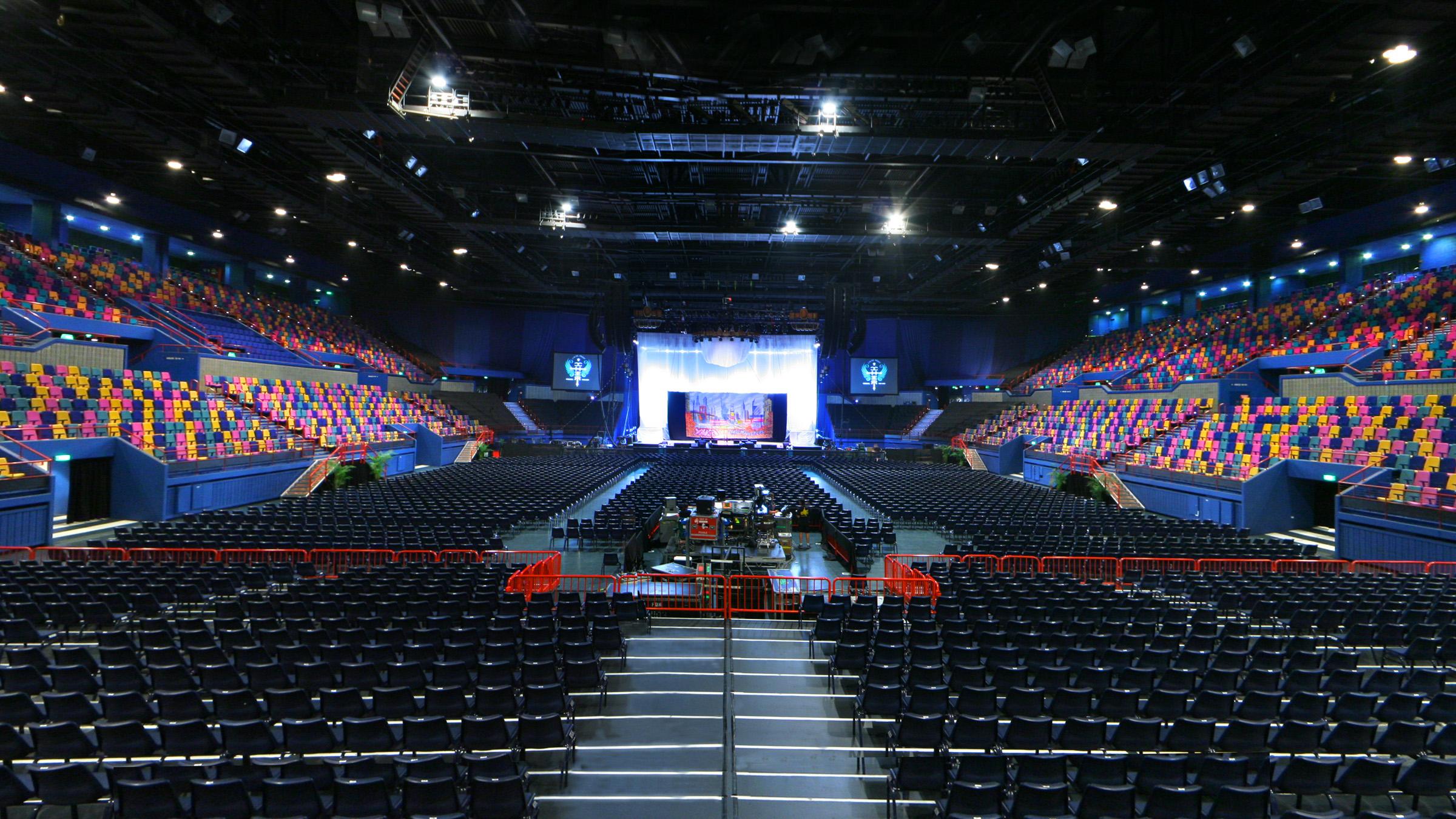 Inside of the Brisbane Entertainment Centre, a massive space filled with audience  chairs and a large stage