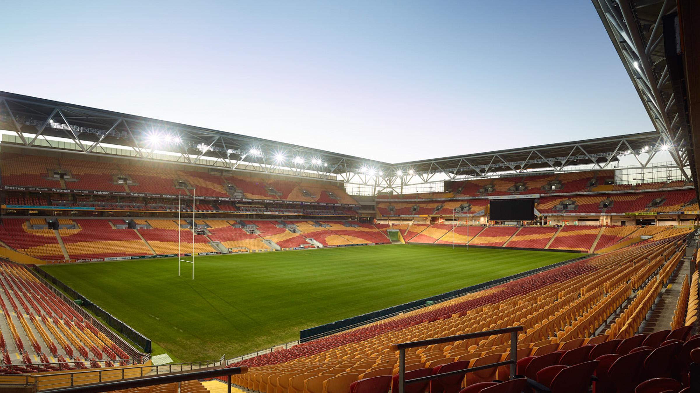 Inside view of empty Suncorp stadium in the afternoon, with the bright stadium lights on