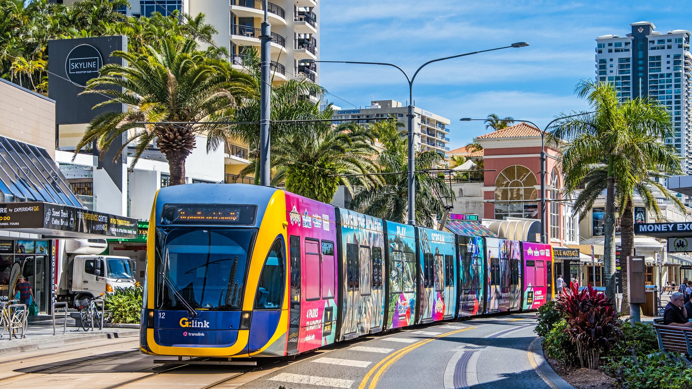 Gold Coast tram rail passing through the centre of Surfers Paradise past restaurants, retail stores and hotels