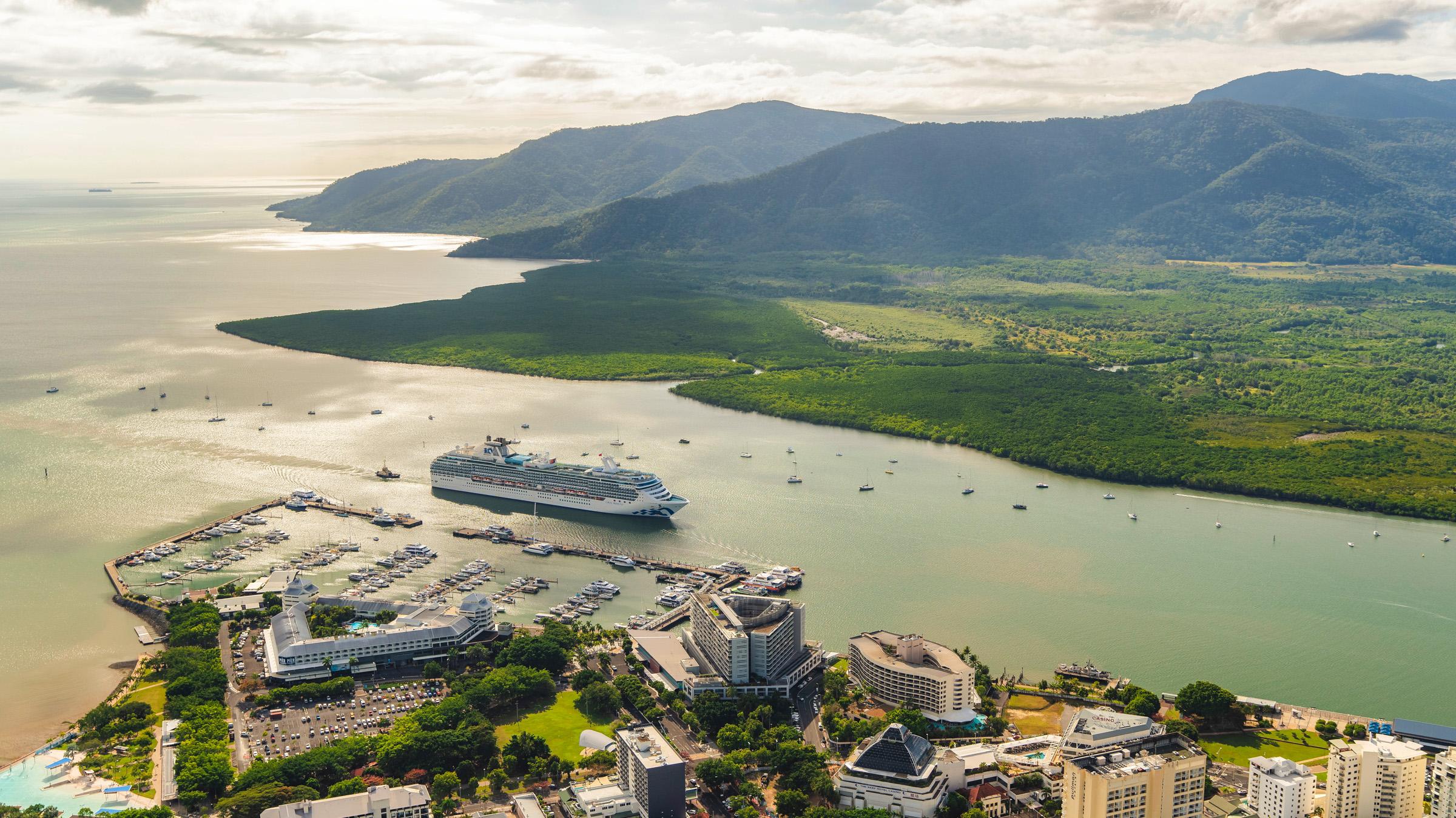 Aerial view of lush Cairns hinterland and Cairns Harbour, with cruise ship coming into dock