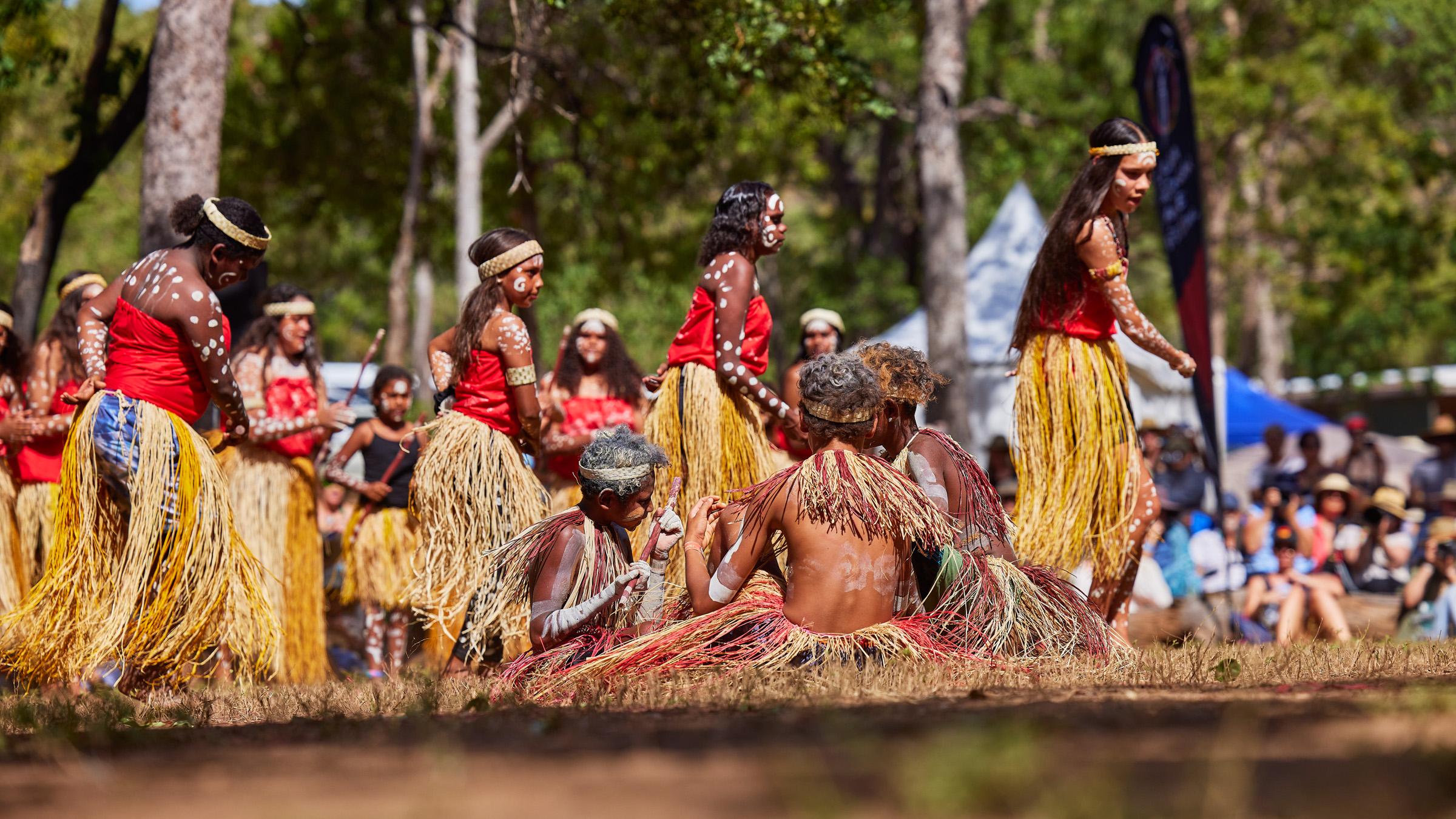 A group of First Nations performers dancing in front of a crowd at the Laura Quinkan Dance Festival