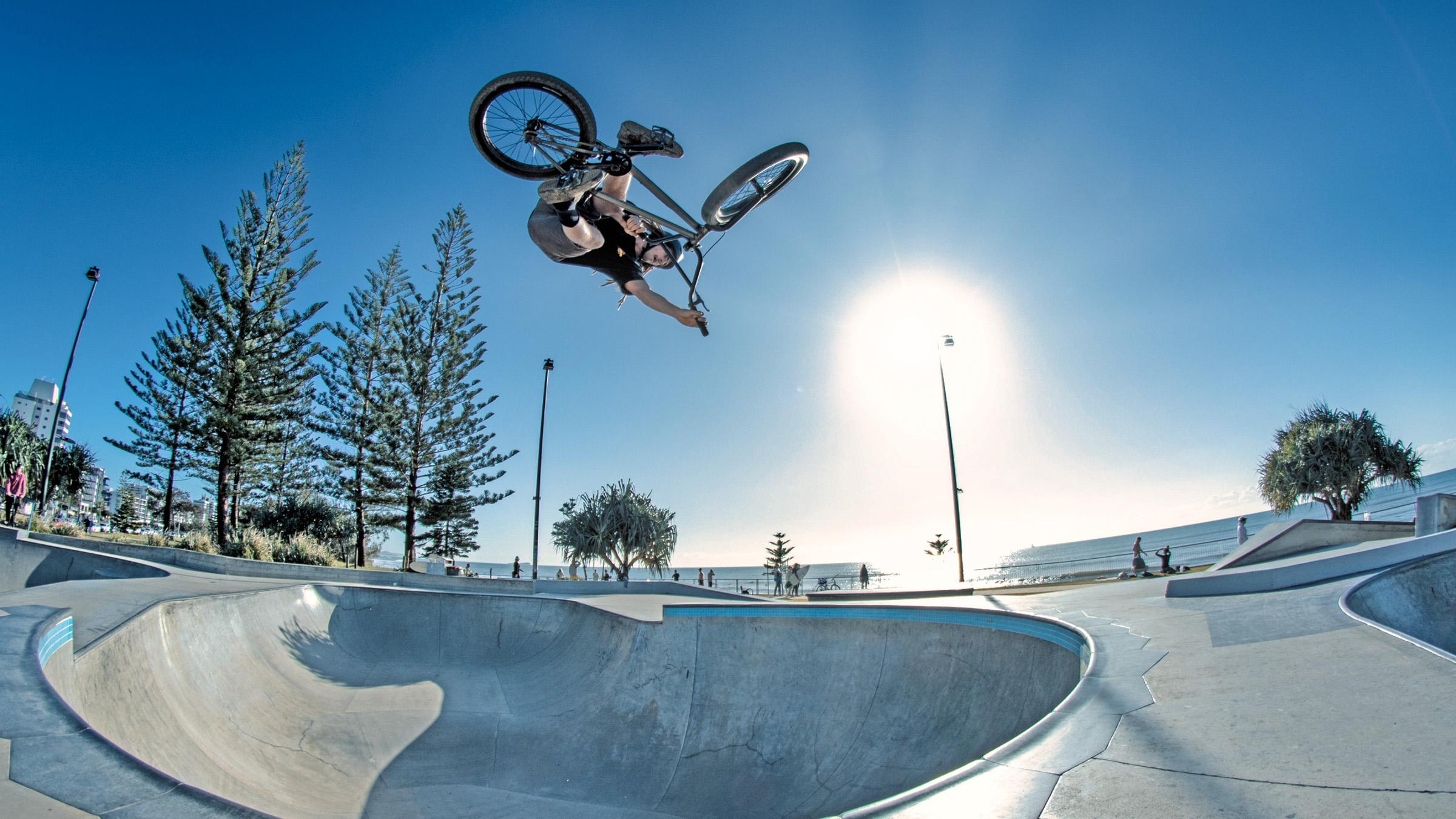 A bike rider in the air doing a trick at Alexandra Headland skate park