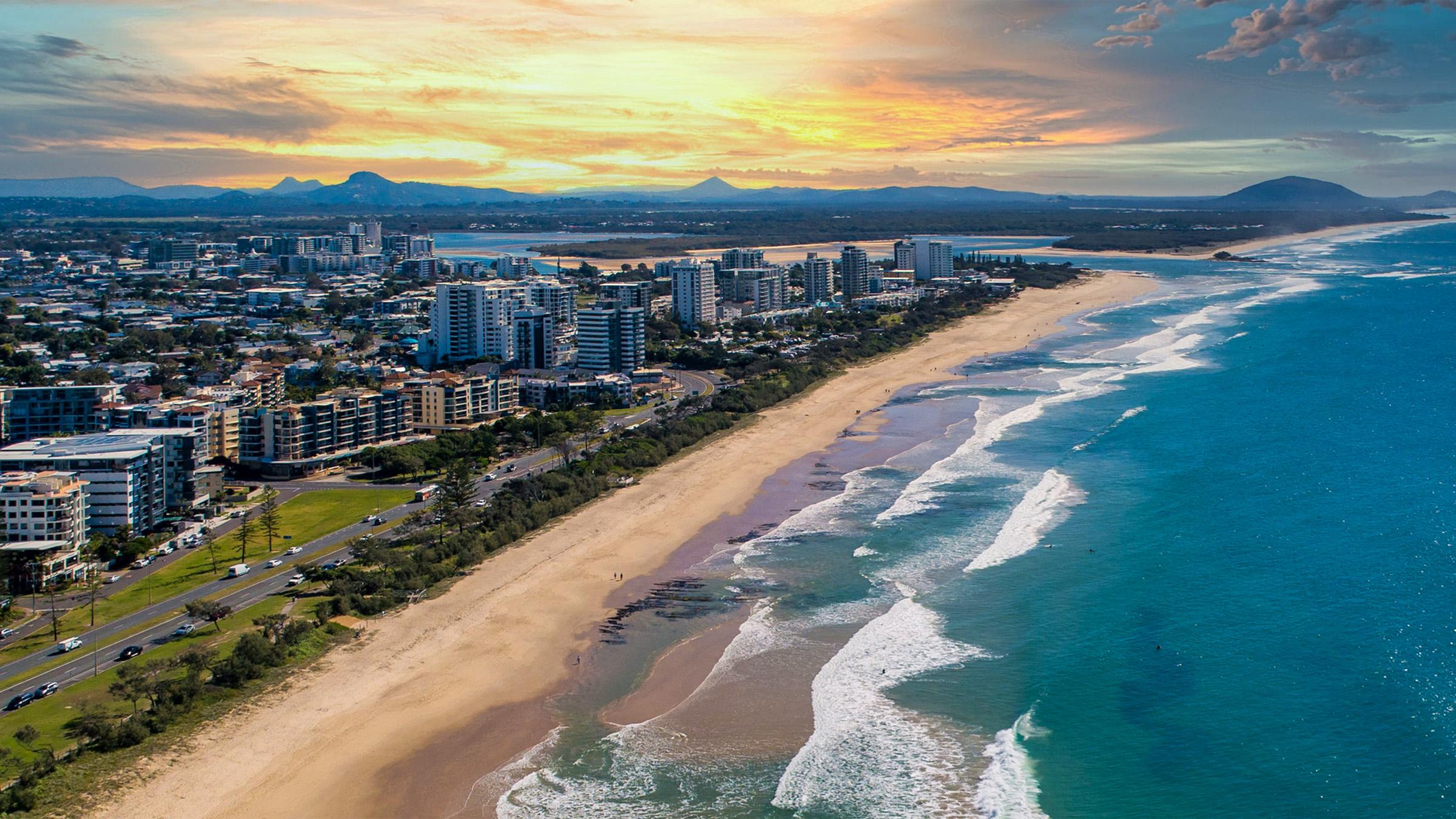 Aerial shot of Mooloolaba beach beachfront hotels during sunset with the Mooloolah River in background